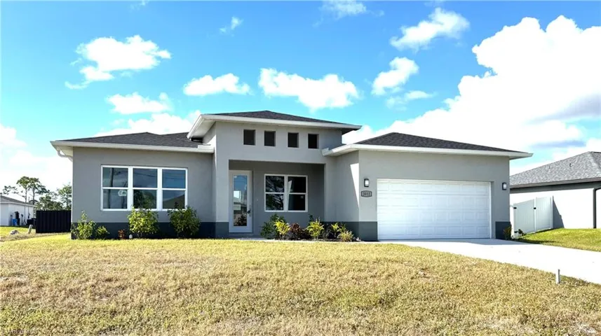 Prairie-style house with a garage and a front lawn