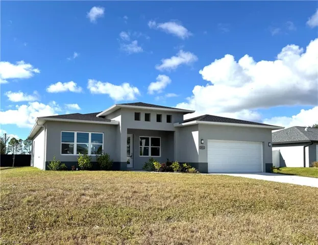 Prairie-style house with a front yard and a garage