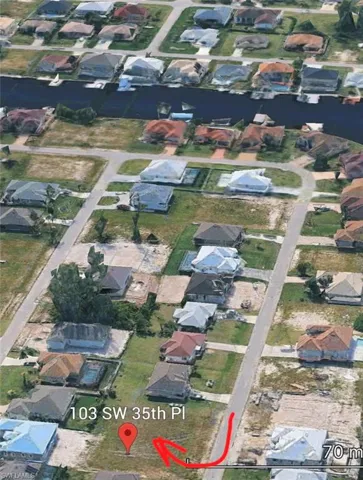 Aerial view of property's location featuring nearby suburban area
