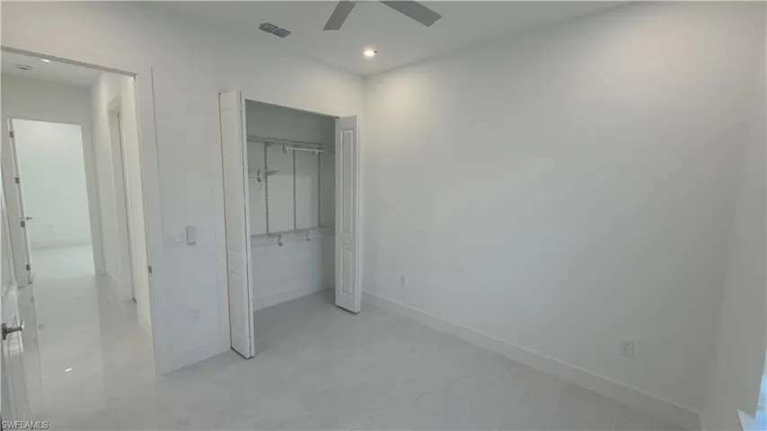 Unfurnished bedroom featuring a closet and a ceiling fan