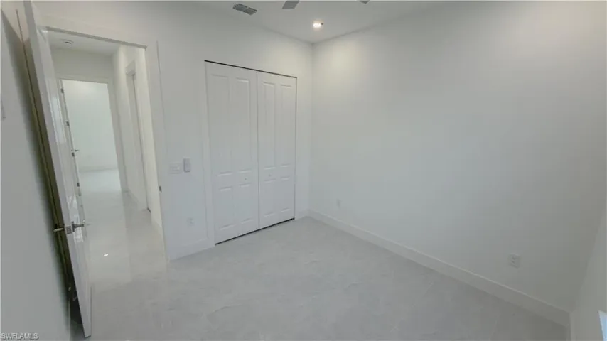 Unfurnished bedroom featuring a closet and ceiling fan