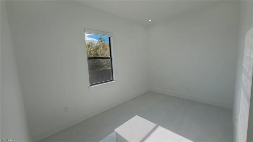 Spare room featuring baseboards and recessed lighting