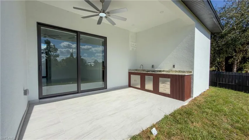 View of patio / terrace featuring an outdoor kitchen and ceiling fan