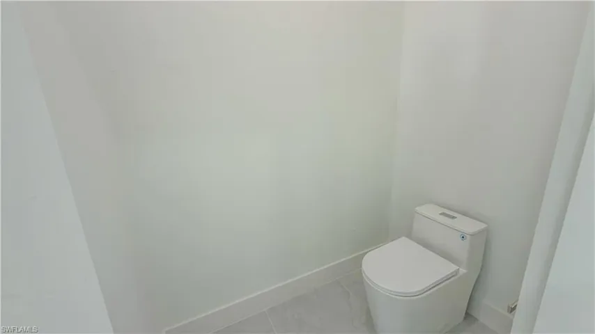 Bathroom with baseboards and marble finish floors