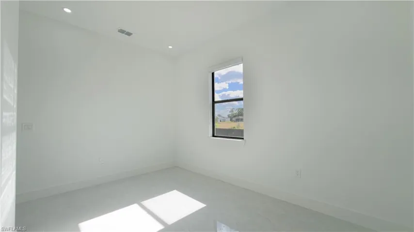 Empty room featuring baseboards and recessed lighting