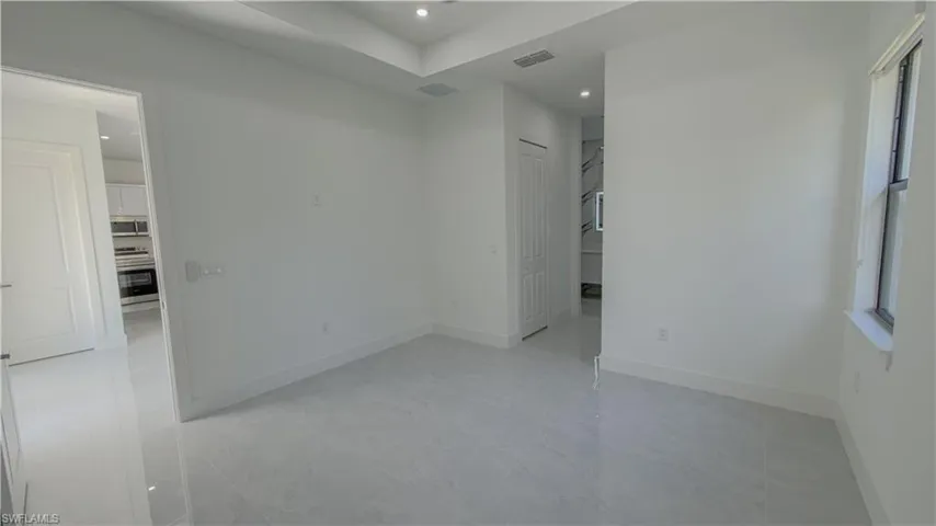 Unfurnished room featuring recessed lighting and baseboards