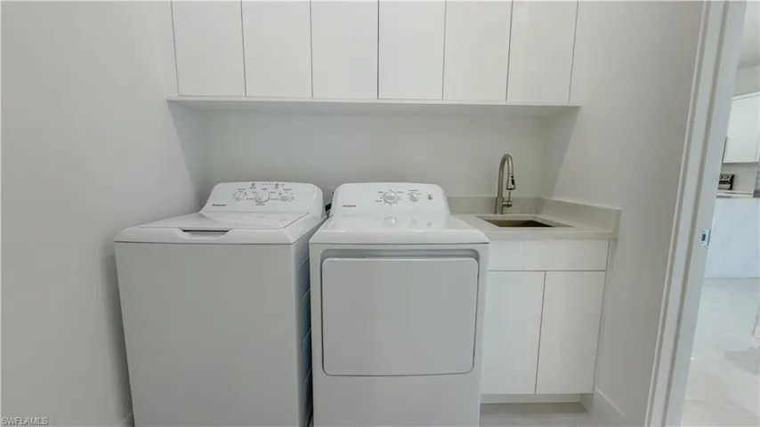 Laundry room with cabinet space and washing machine and clothes dryer