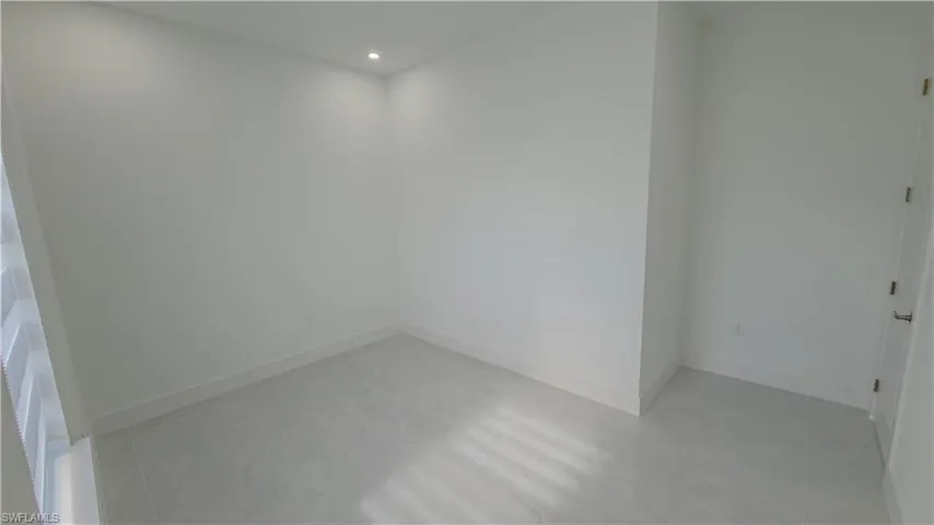 Empty room featuring baseboards and recessed lighting