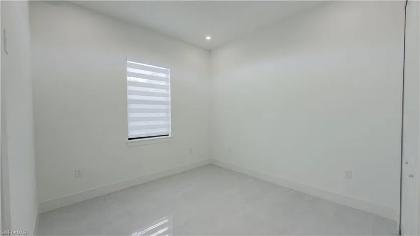 Spare room with baseboards and recessed lighting