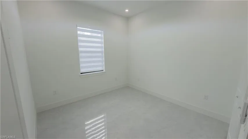 Unfurnished room with baseboards