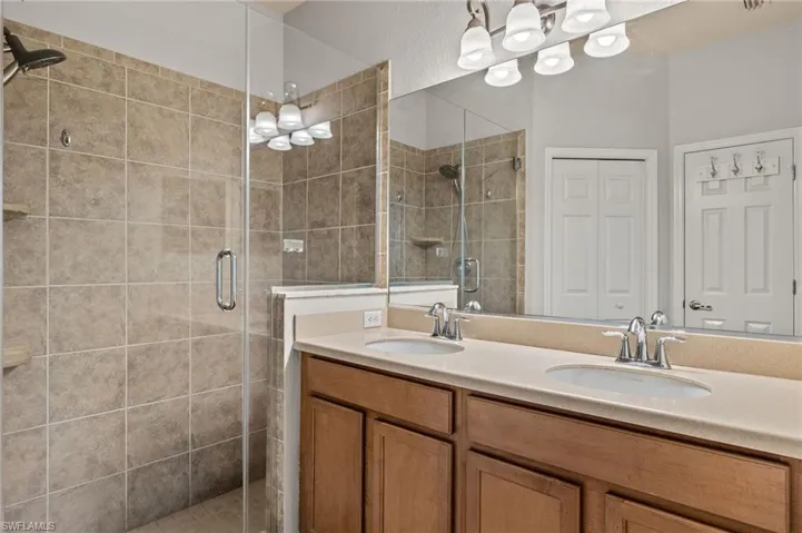 Bathroom with an enclosed shower and vanity