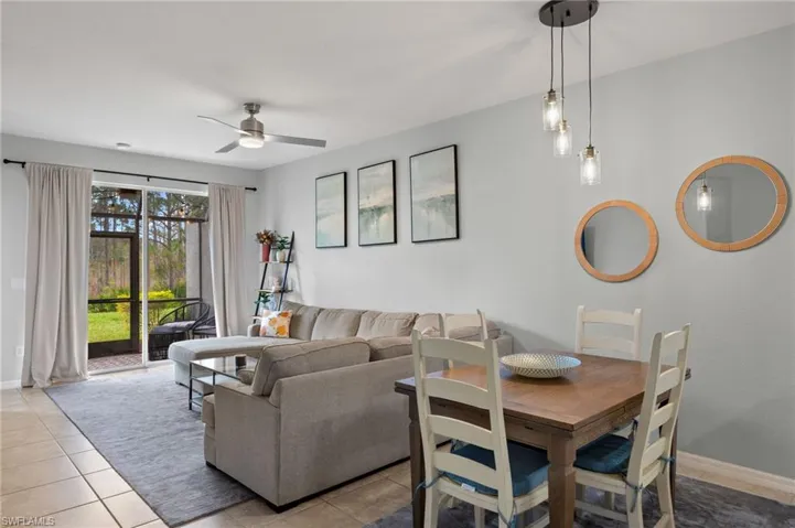 Living room with ceiling fan and light tile patterned floors