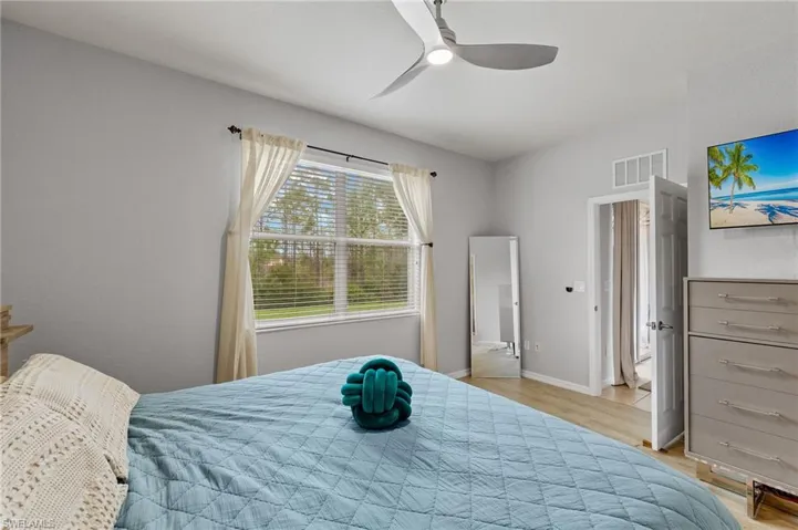 Bedroom featuring ceiling fan and light hardwood / wood-style flooring