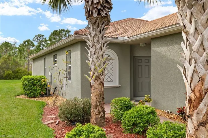 Doorway to property with a yard