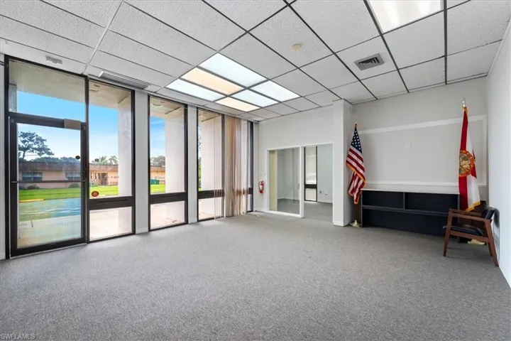Building lobby featuring a wall of windows and a paneled ceiling