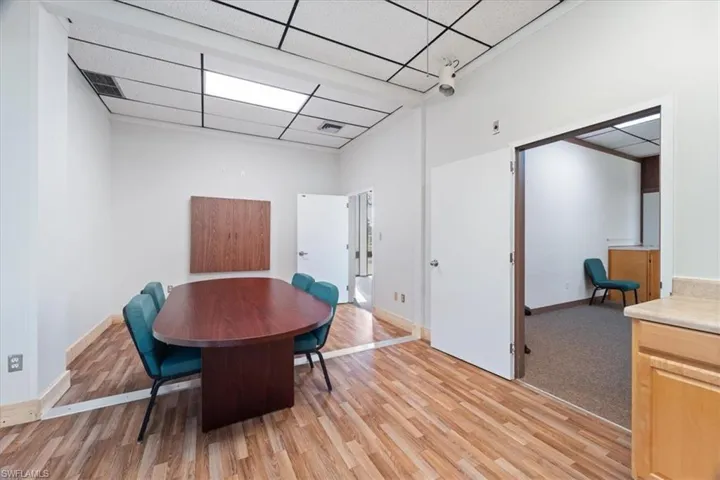 Dining area with a paneled ceiling and light wood finished floors