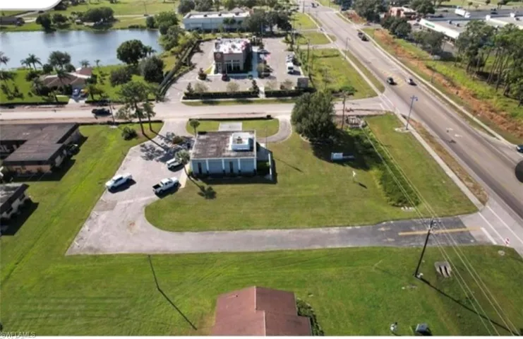 Birds eye view of property with a water view