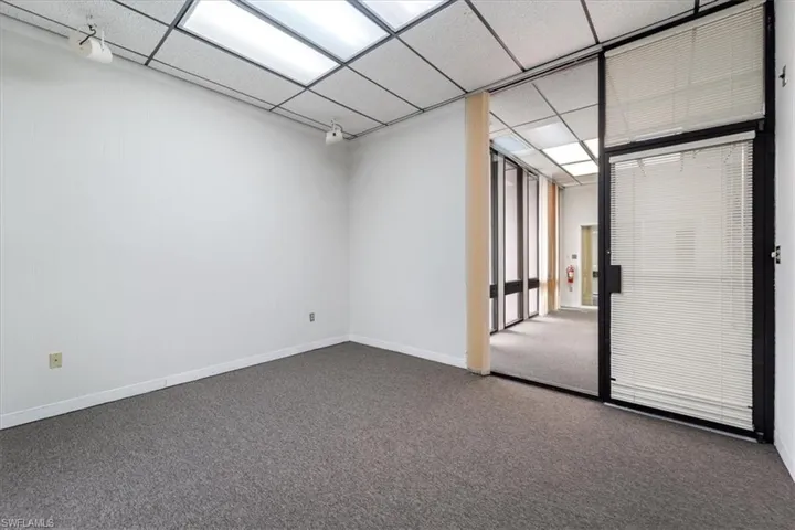 Carpeted empty room with baseboards
