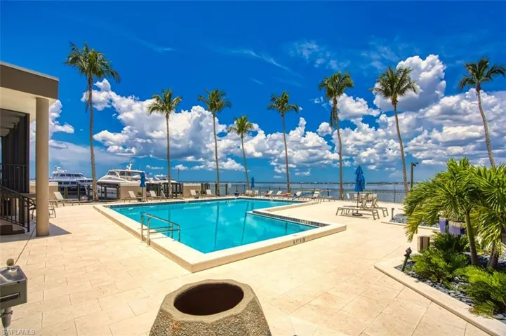 Community pool featuring a patio.  Enjoy a nice swim or sun by the river
