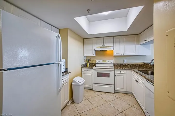 Kitchen featuring white appliances,