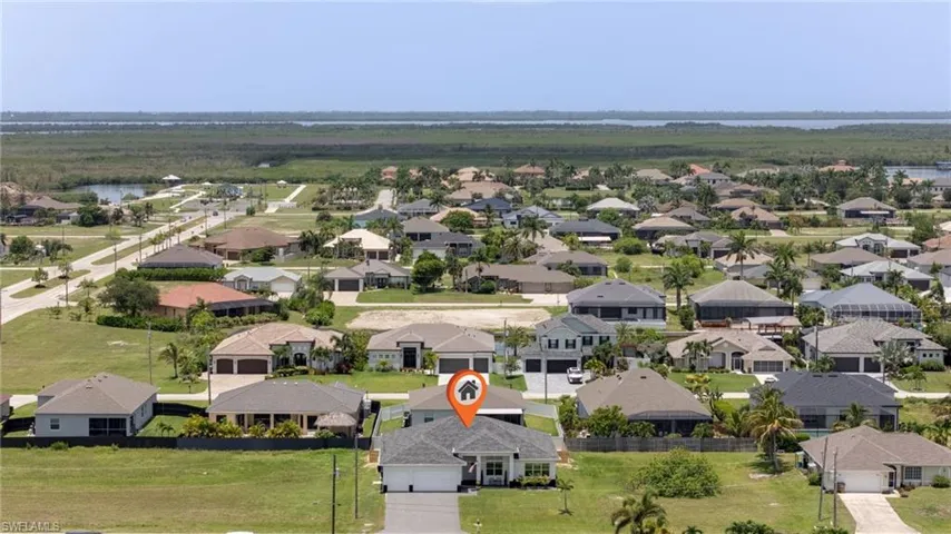 Single-story residence with a gray shingle roof and a paved driveway