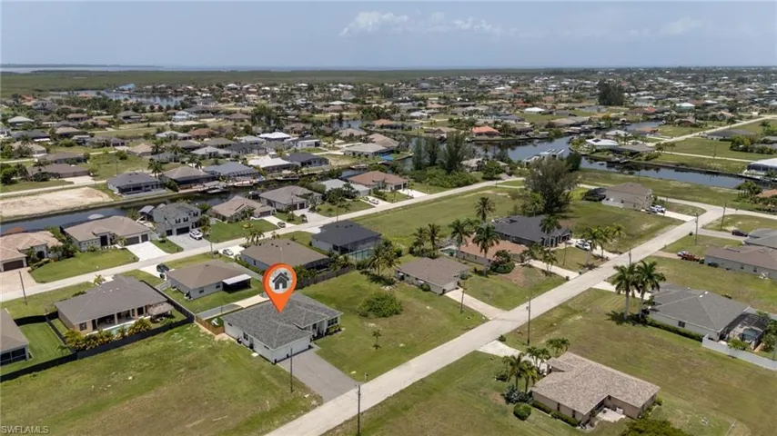 Aerial view of a residential neighborhood featuring numerous properties with canals and water features