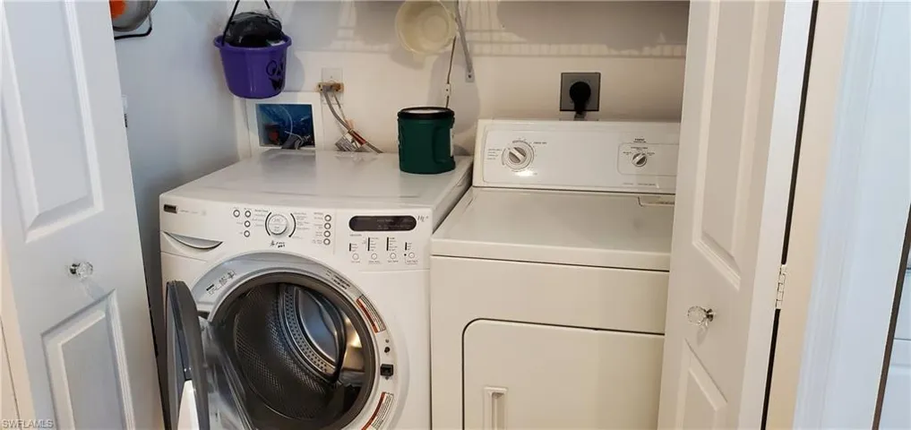 Laundry area featuring laundry area and washer and clothes dryer