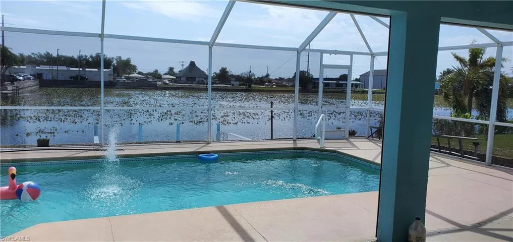 Pool with glass enclosure and a patio