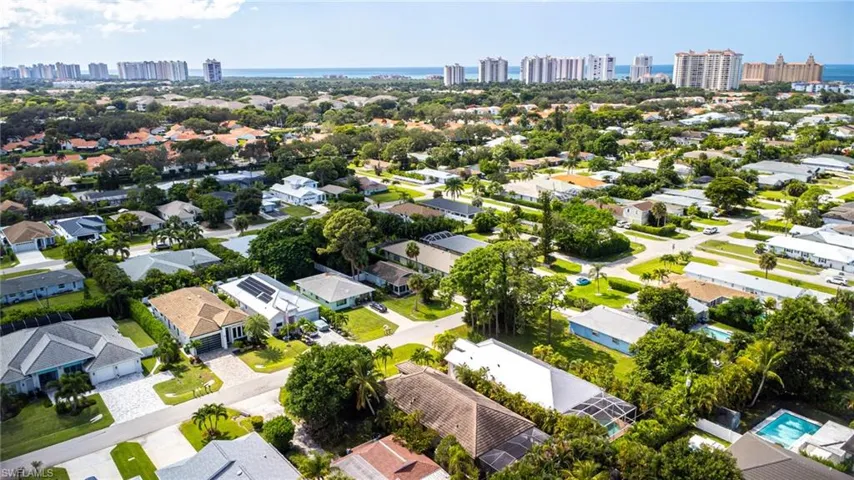 Aerial perspective of suburban area featuring skyline and a large body of water. Home is the one center right at bottom of picture. Metal roof