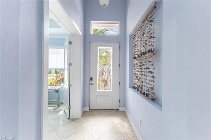 Doorway to outside featuring high ceilings.