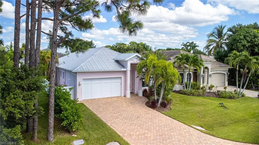 Newer house to the right and no house to the left.