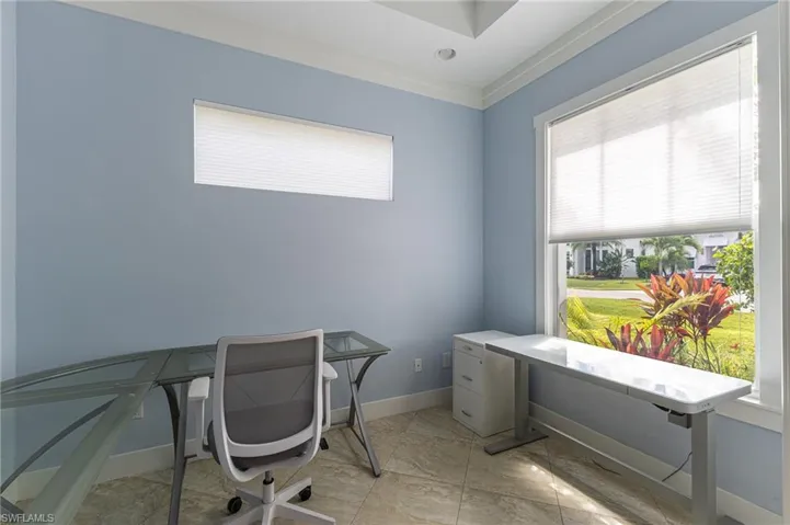 Home office featuring ornamental molding and recessed lighting.