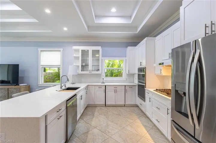 Multi layered tray ceilings in both the Kitchen and Great room.