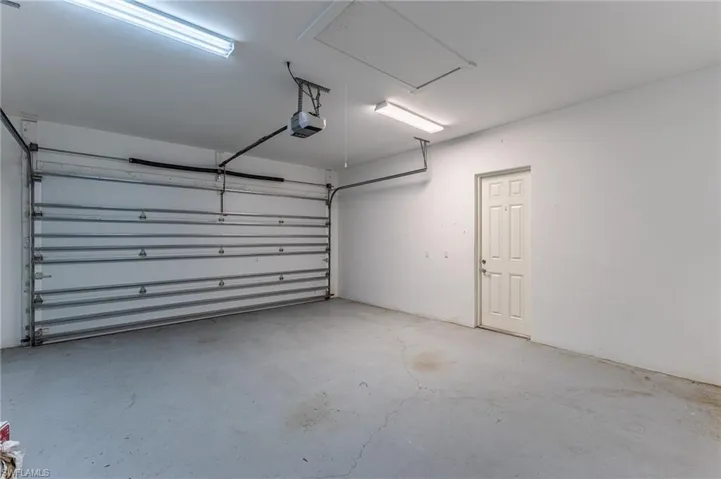 Large 2 car garage with door to side yard.