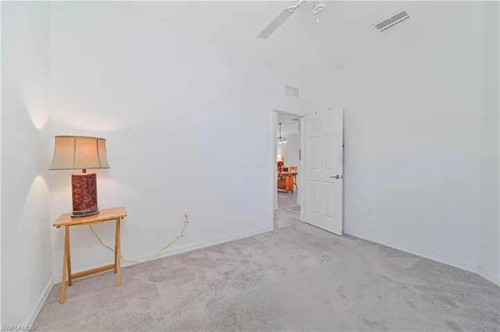 Spare room featuring light carpet and ceiling fan