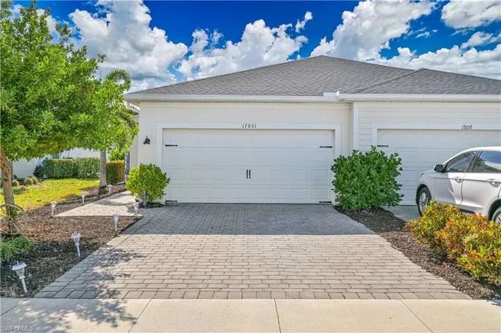 Garage featuring decorative driveway