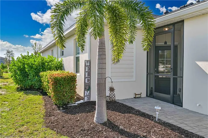 View of exterior entry featuring a patio area and stucco siding