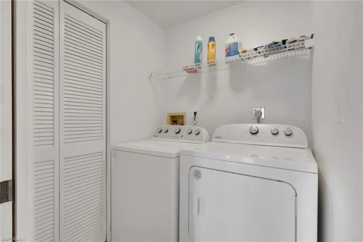 Washroom with washer and clothes dryer