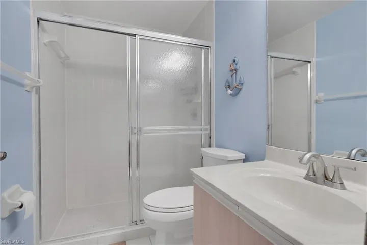 Bathroom featuring vanity and a stall shower