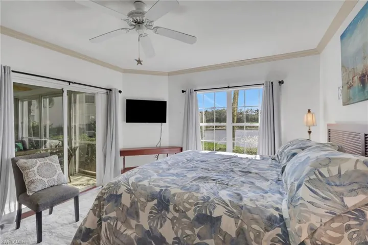 Carpeted bedroom with access to outside, ornamental molding, and ceiling fan