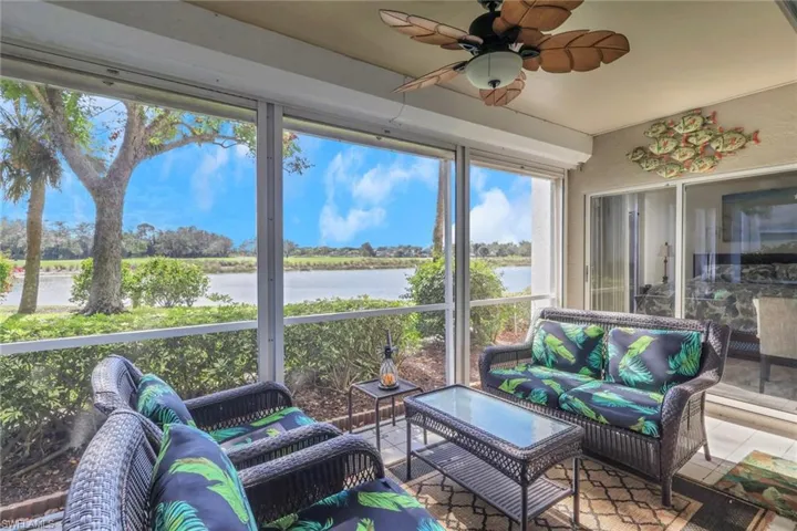Sunroom featuring an outdoor hangout area, ceiling fan, and a water view