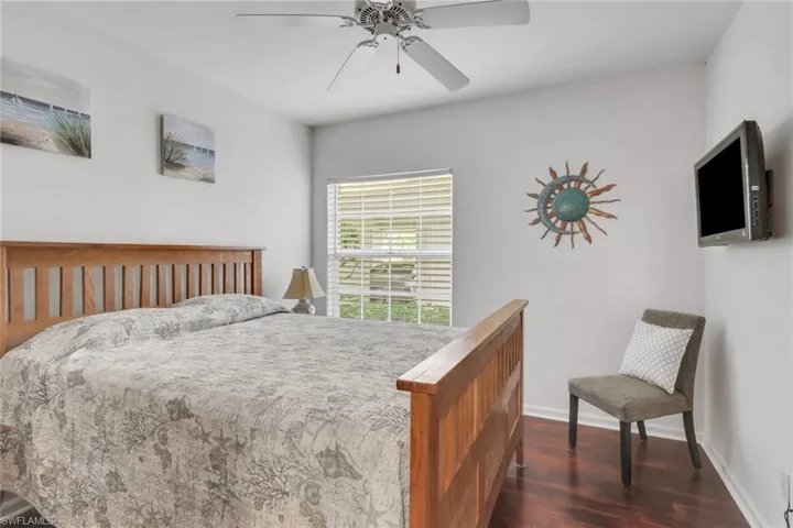 Bedroom featuring dark wood-style flooring and ceiling fan