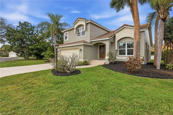 Mediterranean / spanish house featuring a garage, stucco siding, driveway, and a front yard