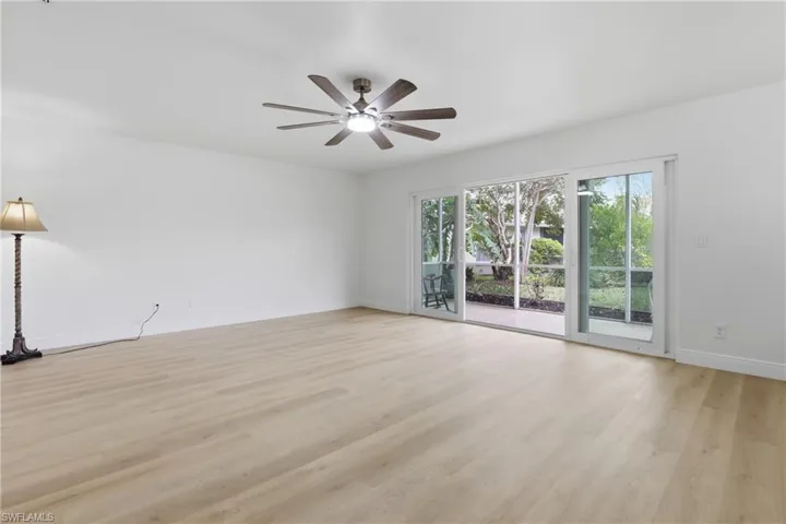 Empty room featuring light wood finished floors and a ceiling fan