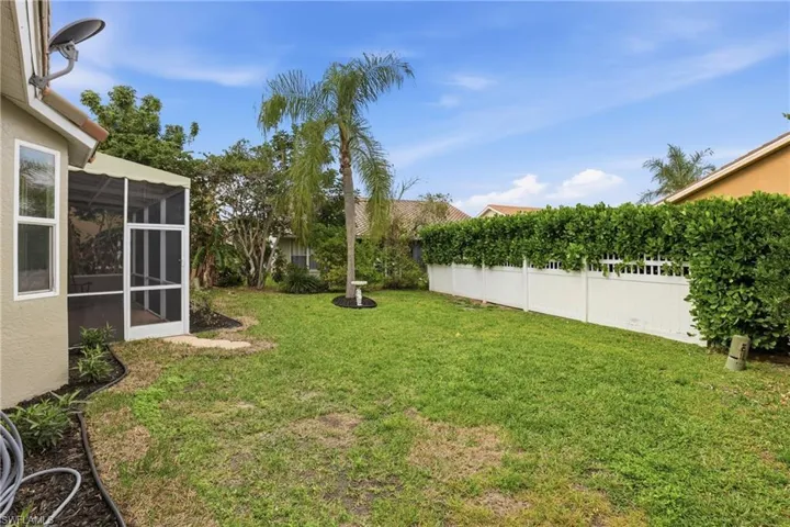 Fenced yard with a sunroom
