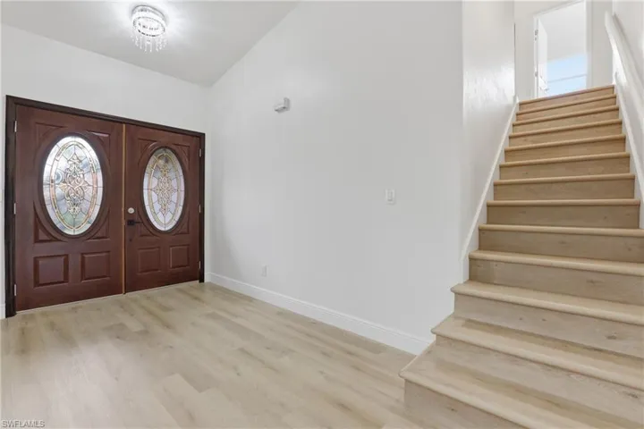 Entryway featuring stairs and light wood-style floors