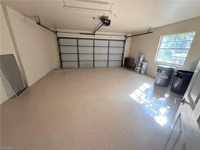 Garage featuring a garage door opener