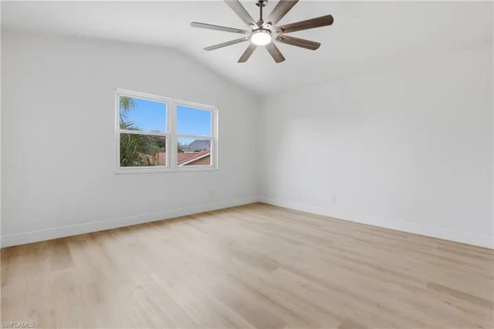 Empty room with light wood-style flooring and a ceiling fan