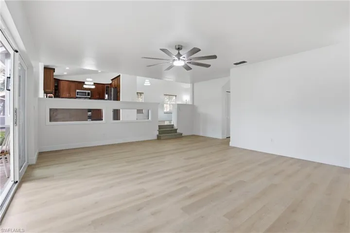 Unfurnished living room featuring ceiling fan, light wood-style flooring, and recessed lighting