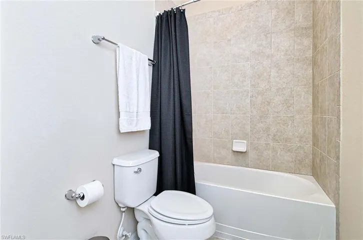 Full bathroom with toilet and shower / tub combo